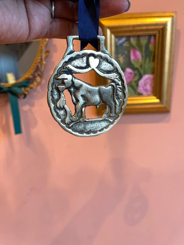 Rare antique Bull in Meadow horse brass harness medallion with leather ribbon, traditional English brass equestrian tack, collectible horse harness decoration, rustic farmhouse wall decor and vintage country home styling.