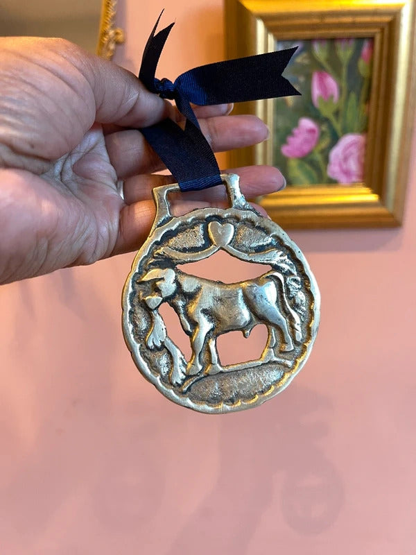 Rare antique Bull in Meadow horse brass harness medallion with leather ribbon, traditional English brass equestrian tack, collectible horse harness decoration, rustic farmhouse wall decor and vintage country home styling.