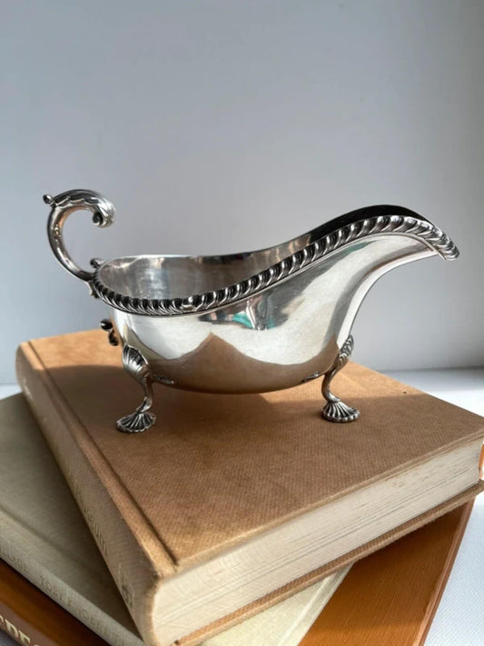 Antique silver plated footed gravy boat with elegant classic design, vintage sauce server for dining table, English tableware, traditional home decor, collectible silver plate and timeless entertaining accessory.