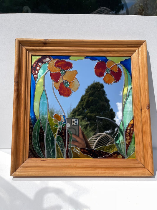 Vintage stained glass floral mirror with poppy design in wooden frame, signed decorative wall mirror, Art Nouveau inspired home decor, cottagecore wall hanging, nature-inspired statement mirror and unique vintage display.