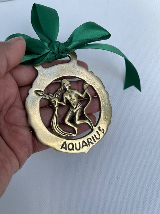 Vintage 1960s horse brass medallion featuring the Aquarius zodiac symbol, solid brass astrology wall decor with an aged vintage finish. Small 7.5cm x 6.5cm equestrian brass plaque, traditional horse brass collectible, Aquarius zodiac gift, celestial home decor, cottagecore gallery wall accent and unique vintage brass decoration. 