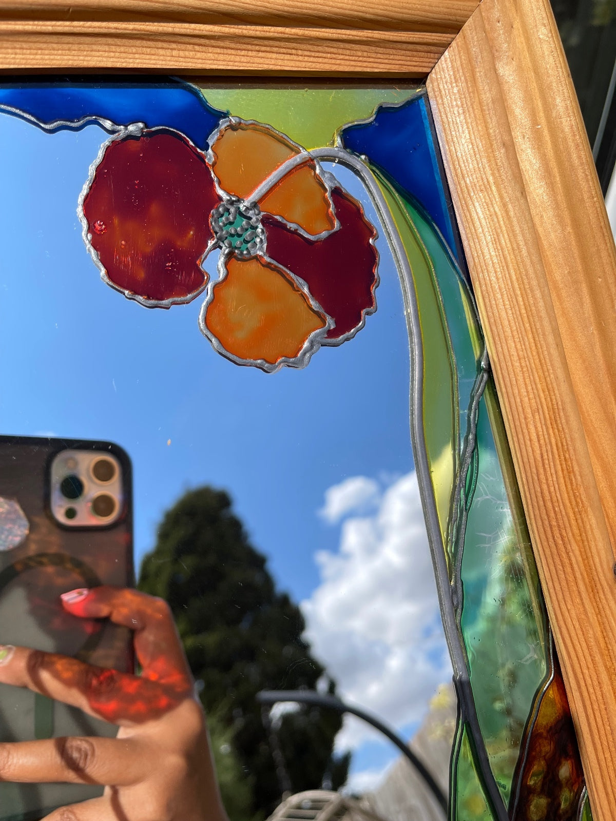 Vintage stained glass floral mirror with poppy design in wooden frame, signed decorative wall mirror, Art Nouveau inspired home decor, cottagecore wall hanging, nature-inspired statement mirror and unique vintage display.