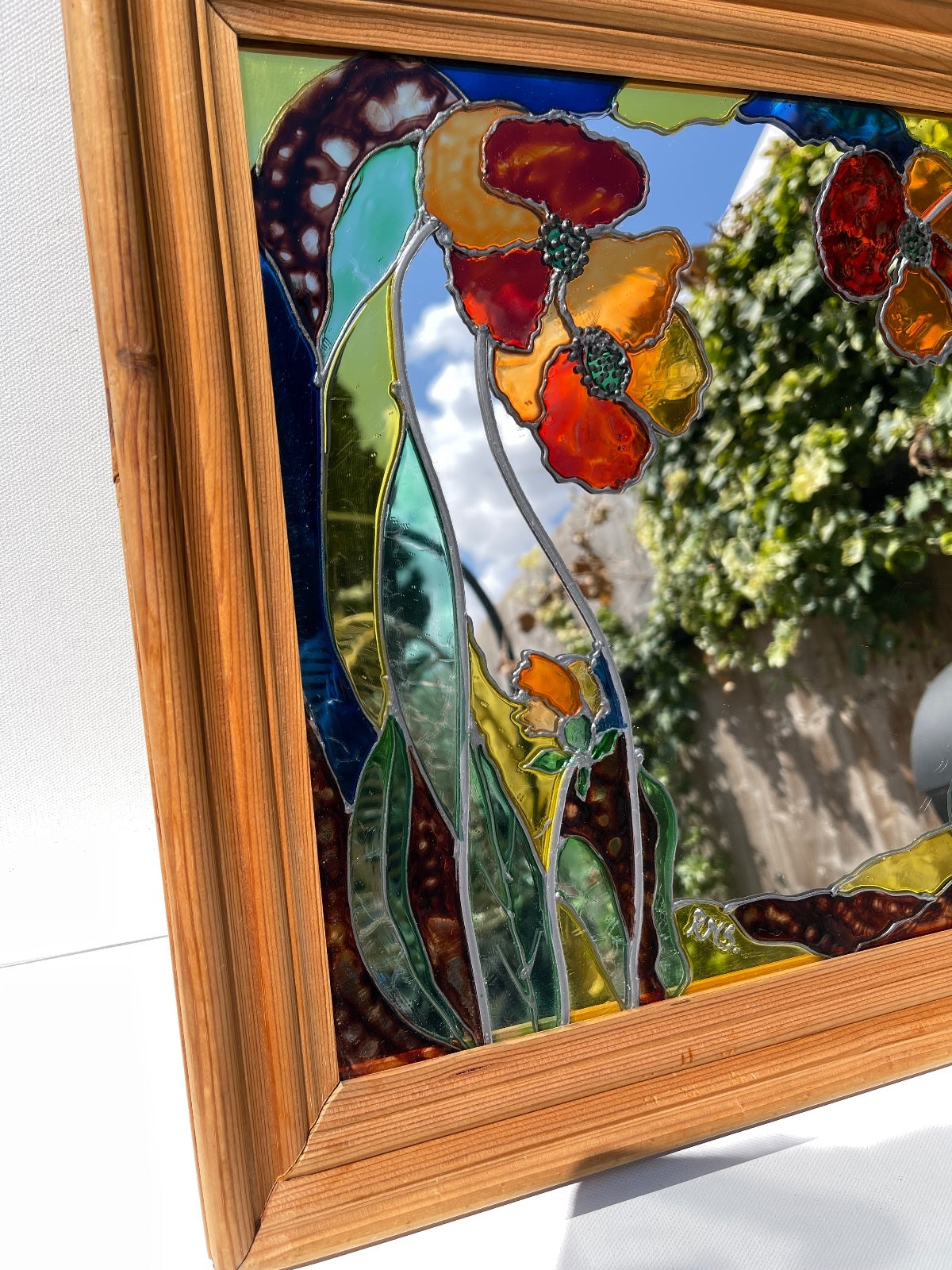 Vintage stained glass floral mirror with poppy design in wooden frame, signed decorative wall mirror, Art Nouveau inspired home decor, cottagecore wall hanging, nature-inspired statement mirror and unique vintage display.