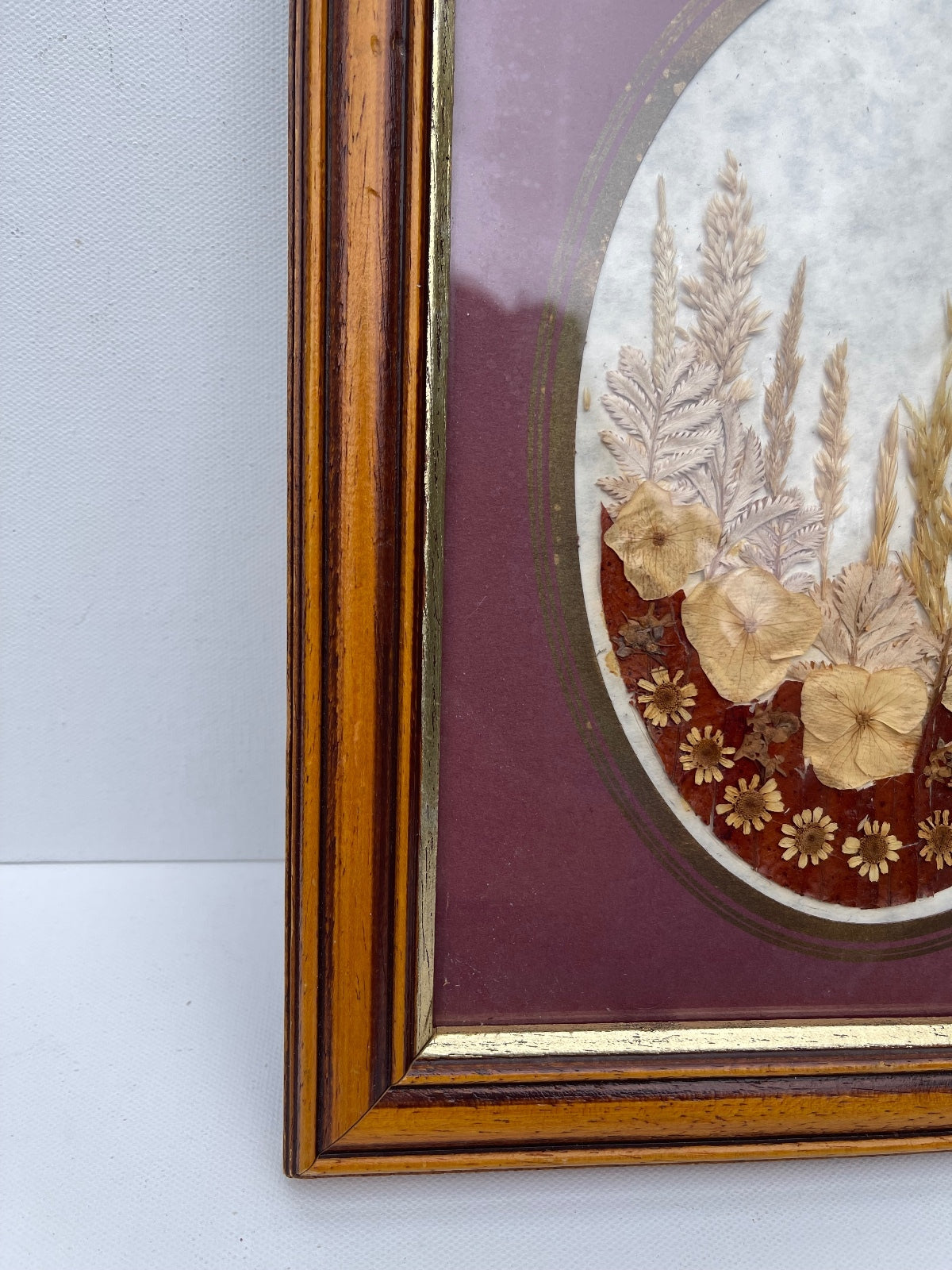 Vintage wooden framed pressed flower display in oval setting
